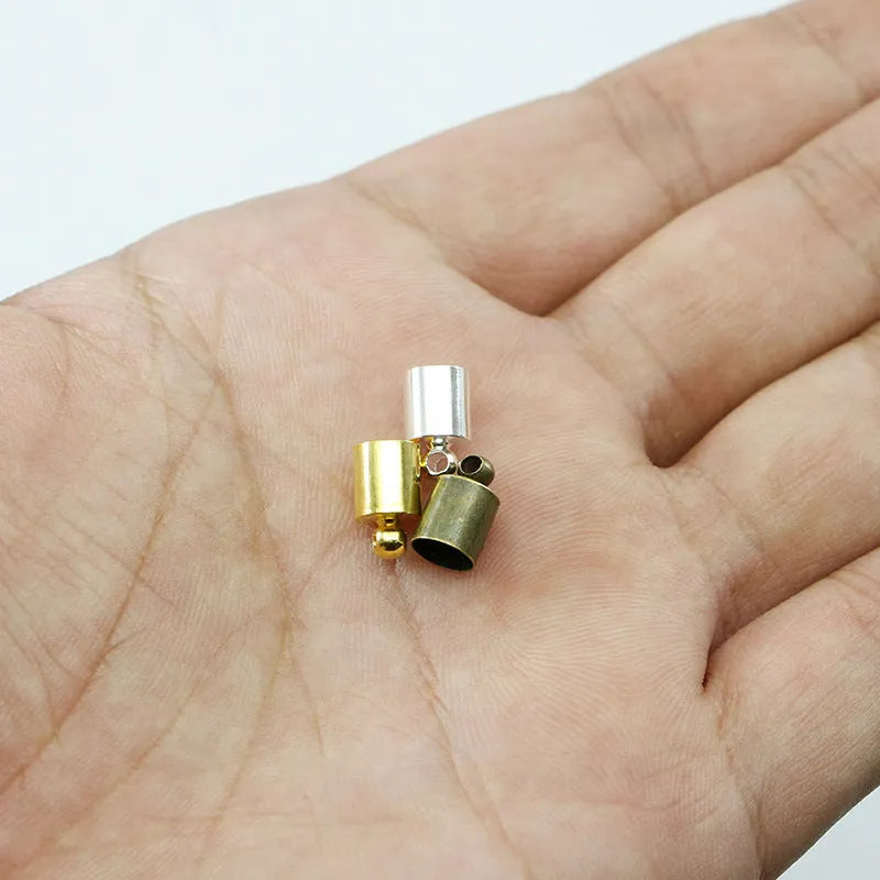 Assorted copper weight caps and tassel caps in gold, silver, and bronze electroplated finishes for jewellery making.