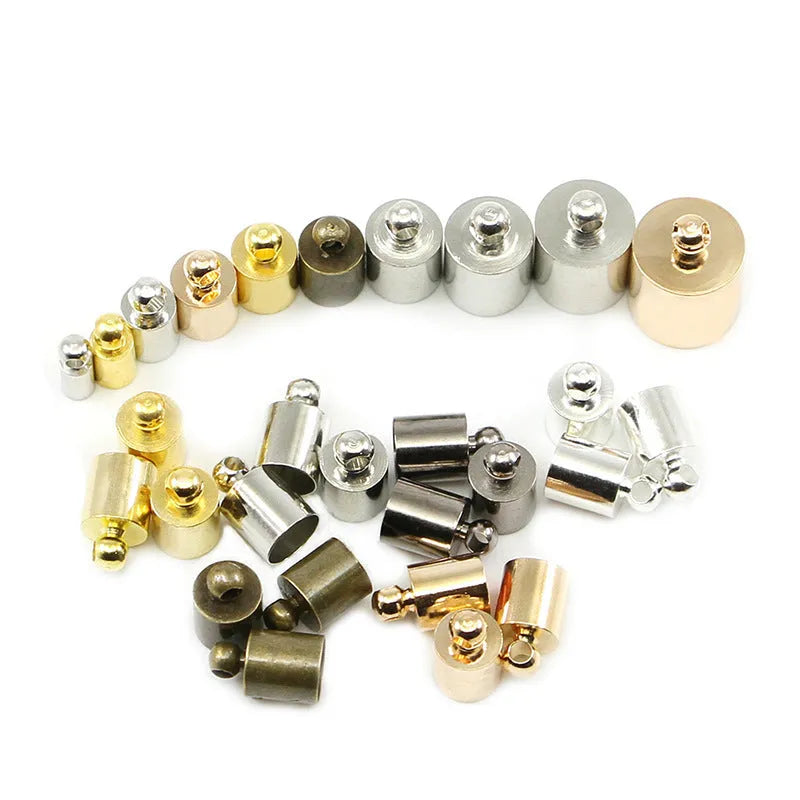Assorted copper weight caps and tassel caps in gold, silver, and bronze electroplated finishes for jewellery making.