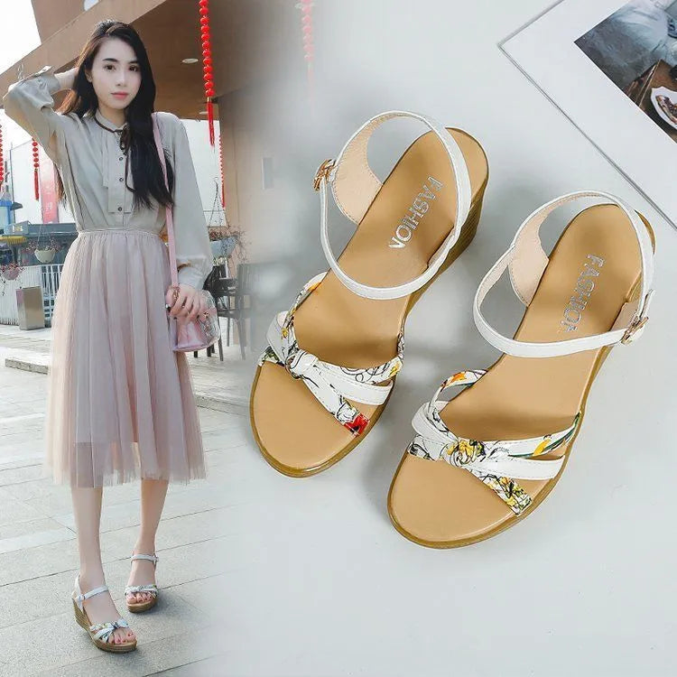 Women's pink wedge sandals with a thick platform sole and buckle strap.