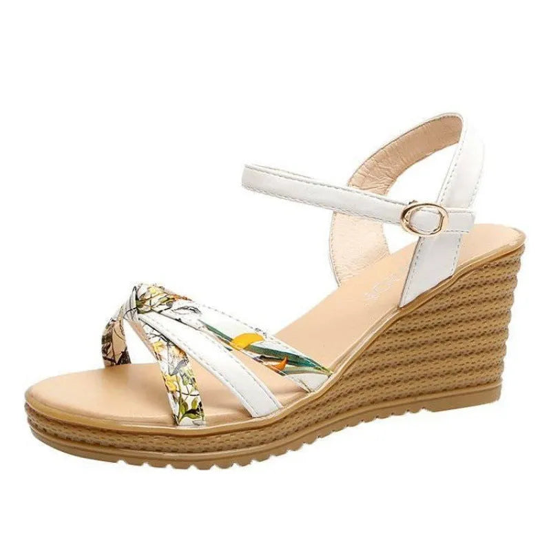 Women's pink wedge sandals with a thick platform sole and buckle strap.