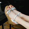 Women's pink wedge sandals with a thick platform sole and buckle strap.