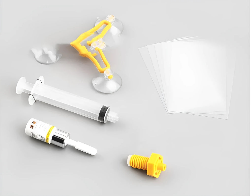 Yellow auto glass repair tool with triangle bracket and 2ml fluid on car windshield