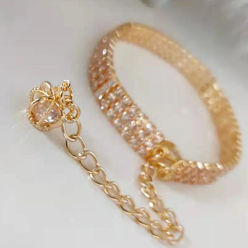 Gold dog collar with crown pattern and three drain diamond rhinestone detail on copper base
