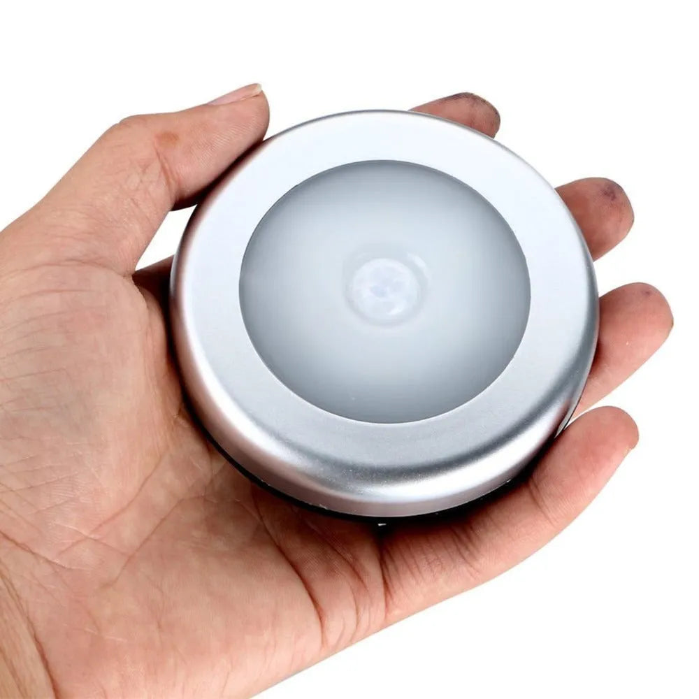 Silver wireless motion sensor night light showing compact square design and LED array.
