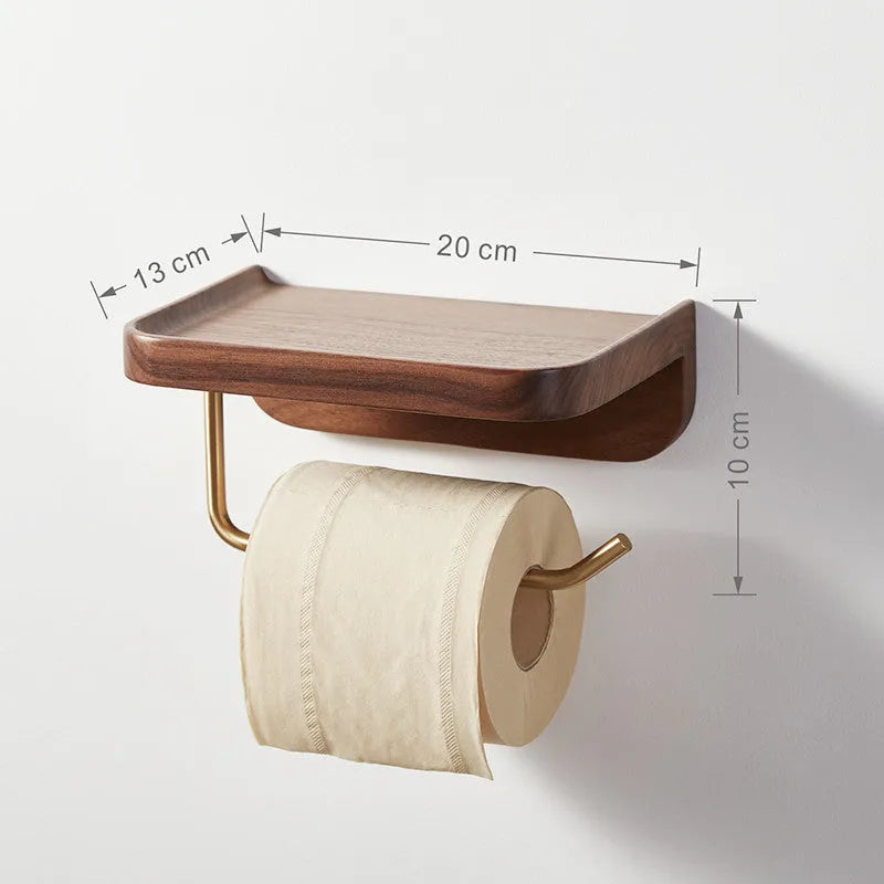 Solid walnut wood and brass wall-mounted paper towel holder on a wall.