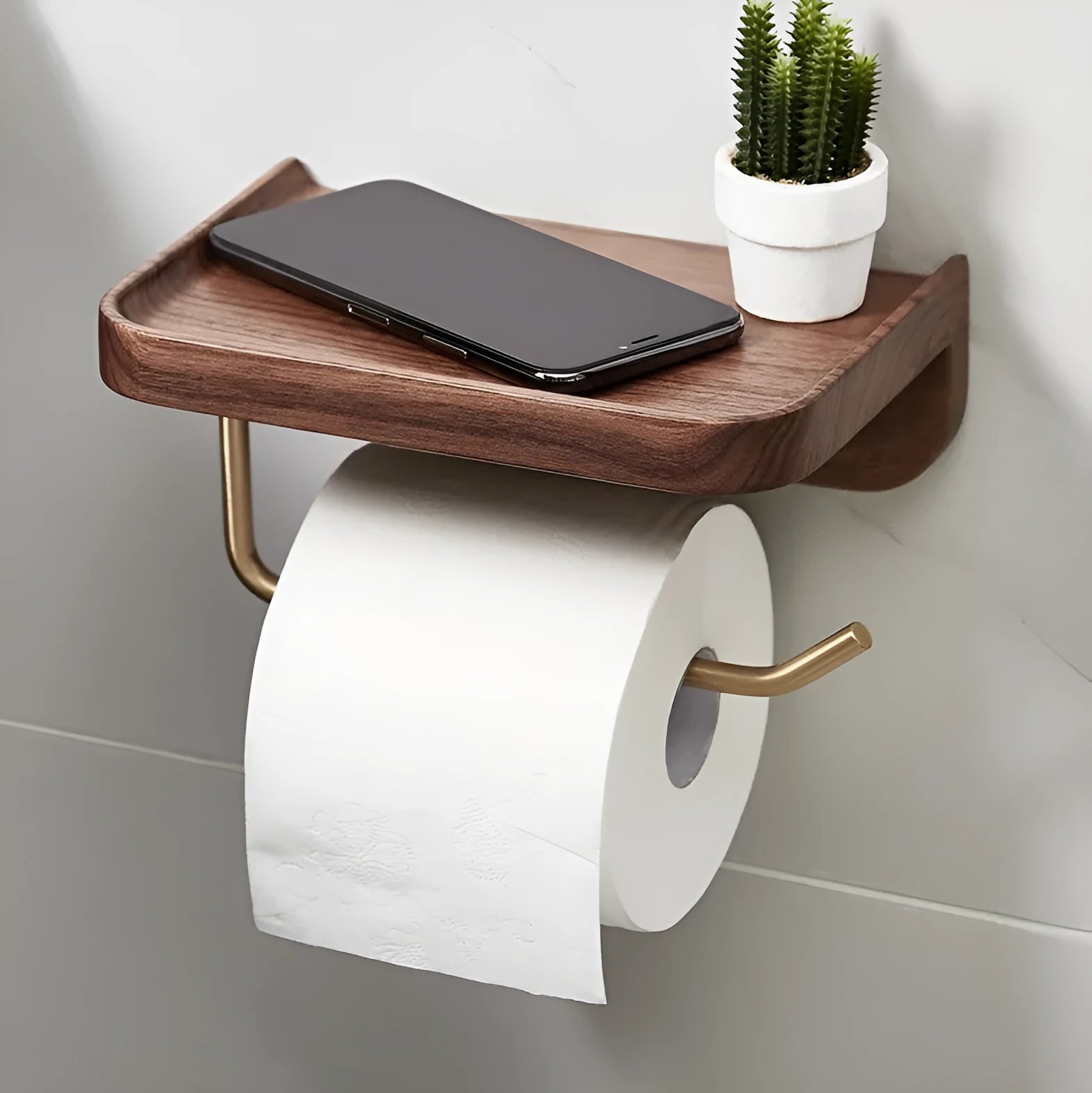 Solid walnut wood and brass wall-mounted paper towel holder on a wall.