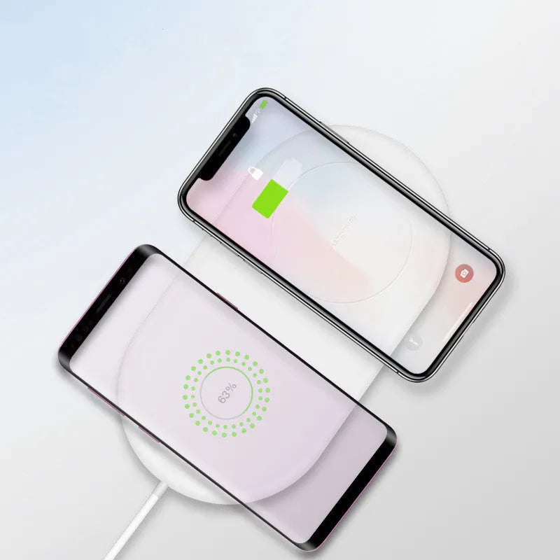 White dual wireless charging pad for two mobile phones.