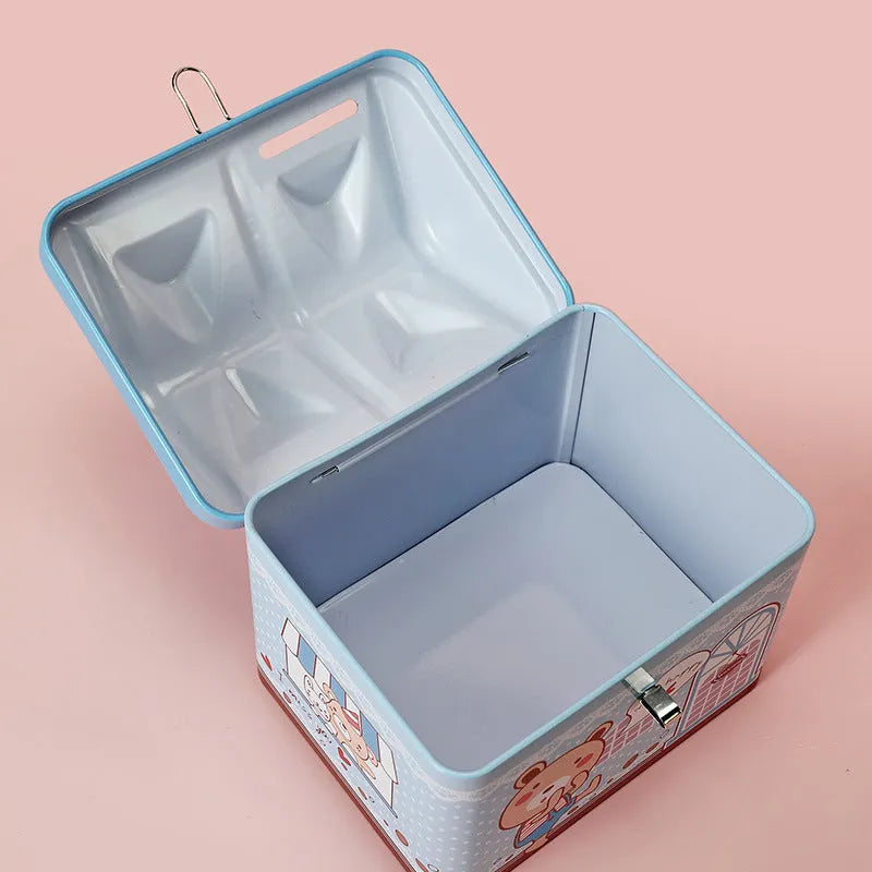 Blue house-shaped tinplate piggy bank for coin saving on a wooden desk