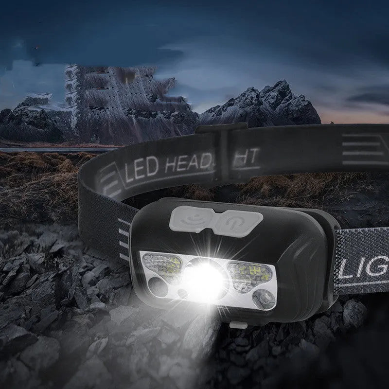 Black USB rechargeable sensor headlight with white and red LEDs, showing motion sensor activation zone