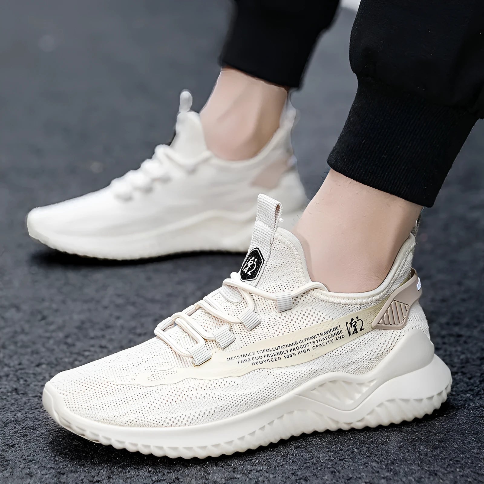 Men's white low-top mesh sports shoes with rubber sole and front laces on a plain background