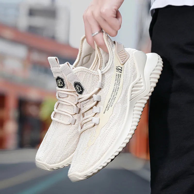 Men's white low-top mesh sports shoes with rubber sole and front laces on a plain background