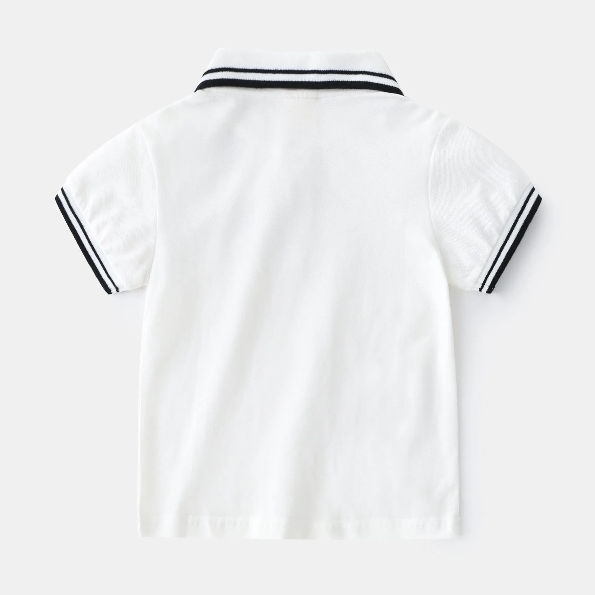 Boys' plain cotton polo shirt with short sleeves and round neck in white or black colours