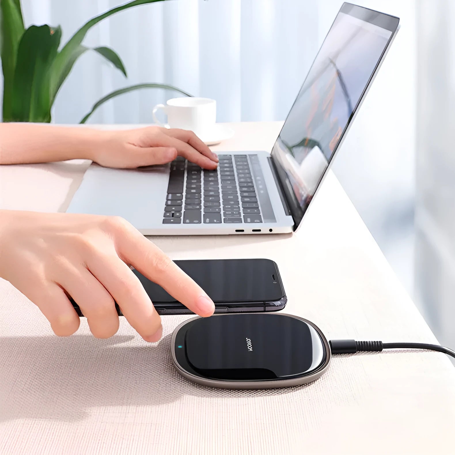 Black or white 15W wireless charger with a glass top and zinc alloy body on a desk.