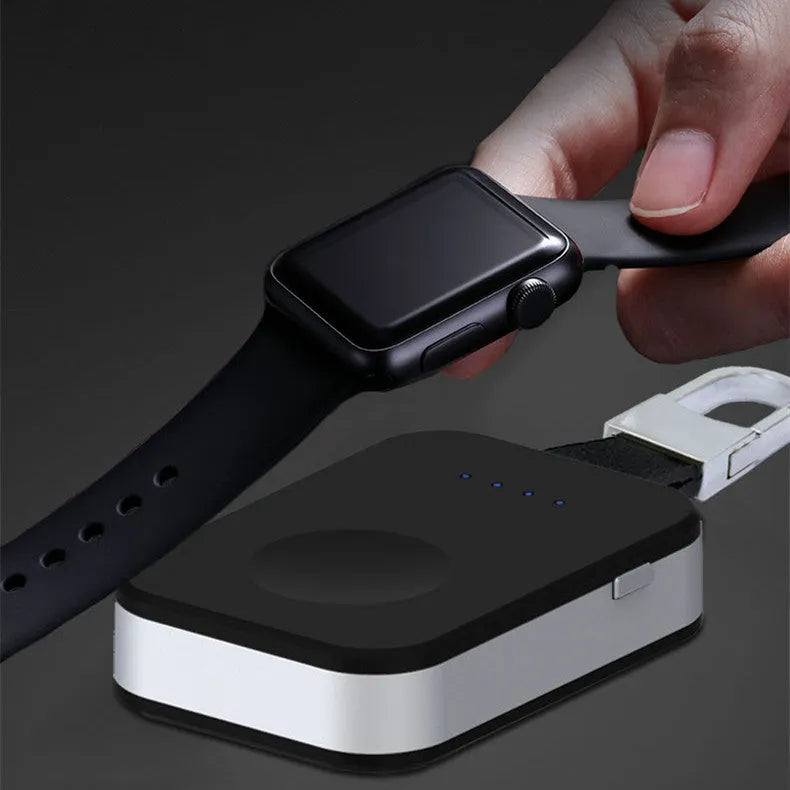Black Apple Watch wireless charging power bank on a keyring, showing compact size.