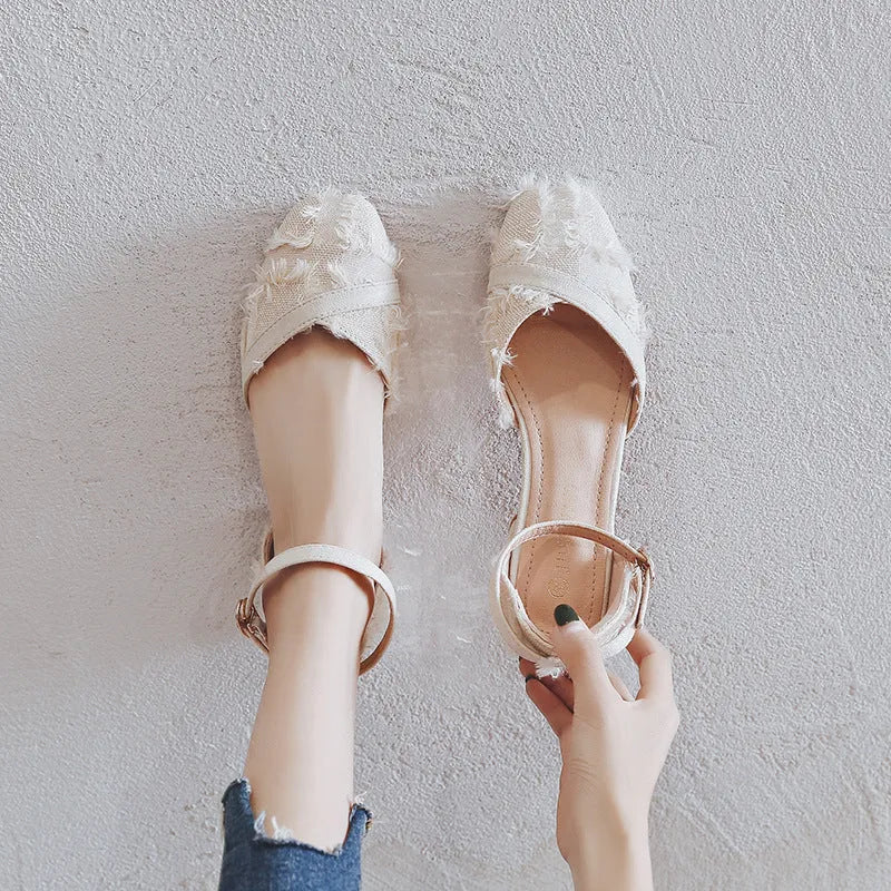 Womens apricot suede ankle strap low heel flats on a white background