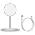 Black Swan magnetic wireless charging stand holding an iPhone 12 upright on a wooden desk.