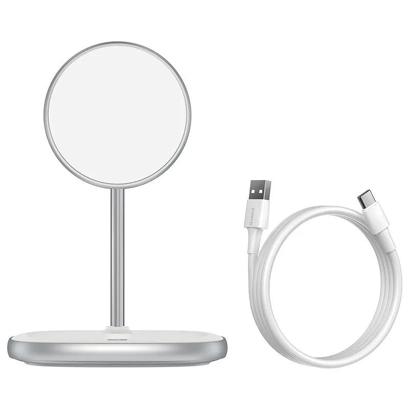 Black Swan magnetic wireless charging stand holding an iPhone 12 upright on a wooden desk.
