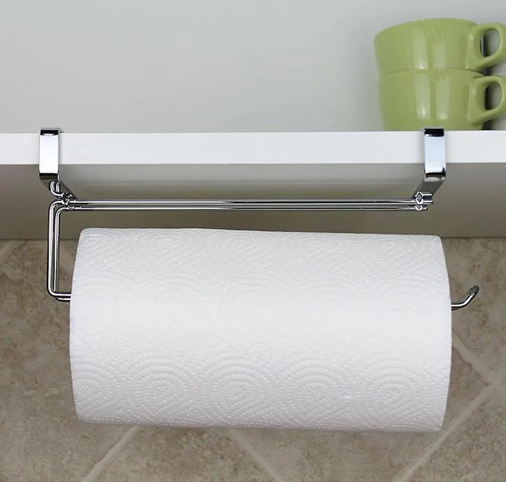 Silver stainless steel wire towel rack hanging on a kitchen cabinet door.