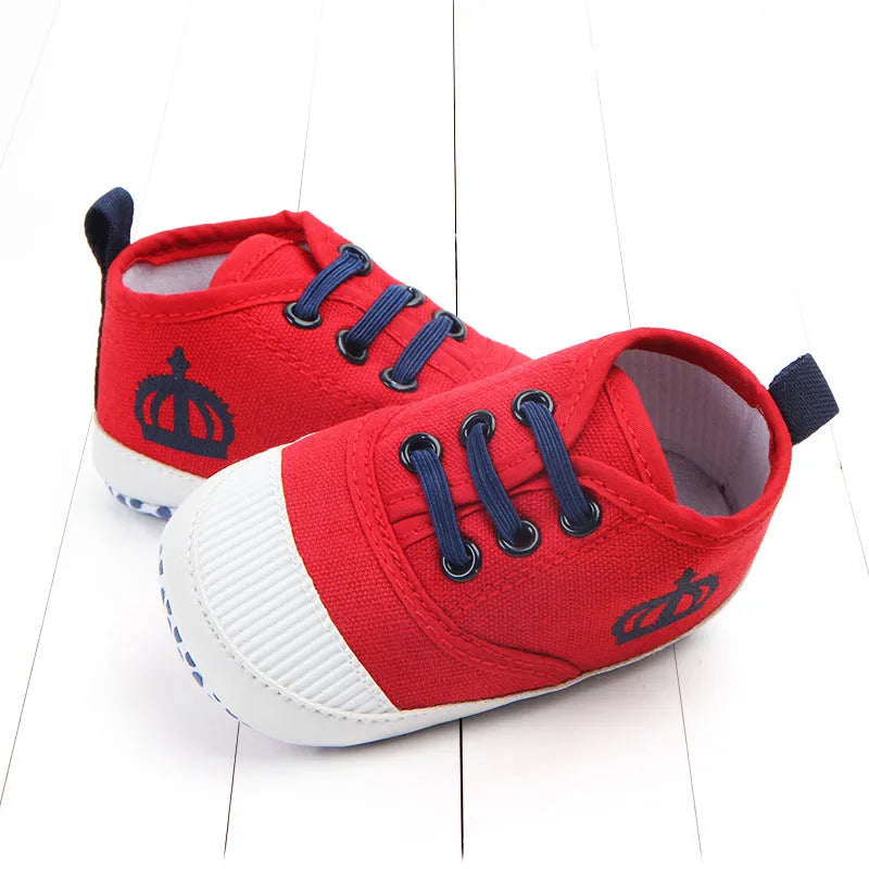 Canvas toddler shoes with elastic band in red and white on neutral background