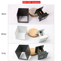 Square black aluminium alloy LED wall lamp mounted on a brick wall, showing 360-degree light emission.