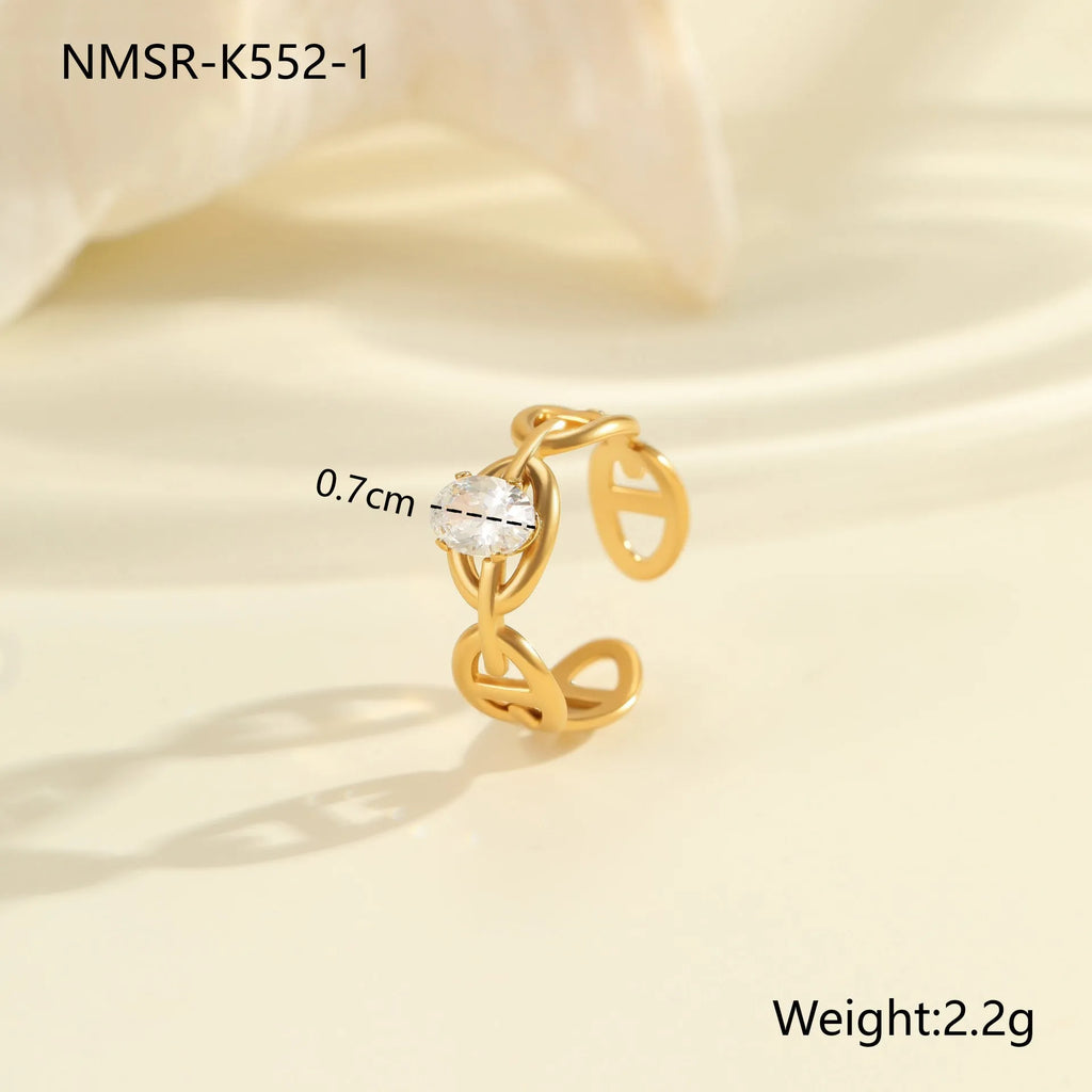 Stainless steel geometric zircon ring with open mouth adjustable design on a woman's hand.