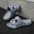 Khaki personalised skull design EVA slippers on a tiled floor, unisex Halloween flip-flops for indoor outdoor use