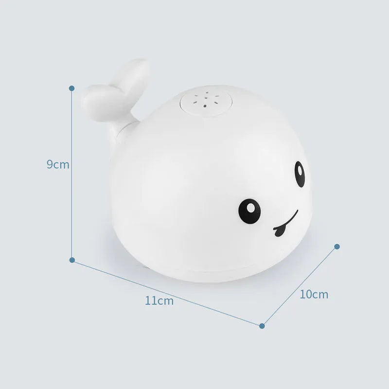 White and blue whale-shaped electric bath toy spraying water with coloured lights flashing