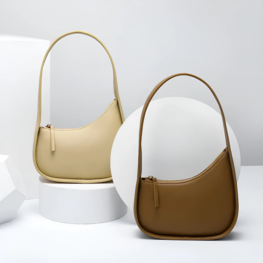 Small brown leather crescent shaped women's shoulder bag with wide strap