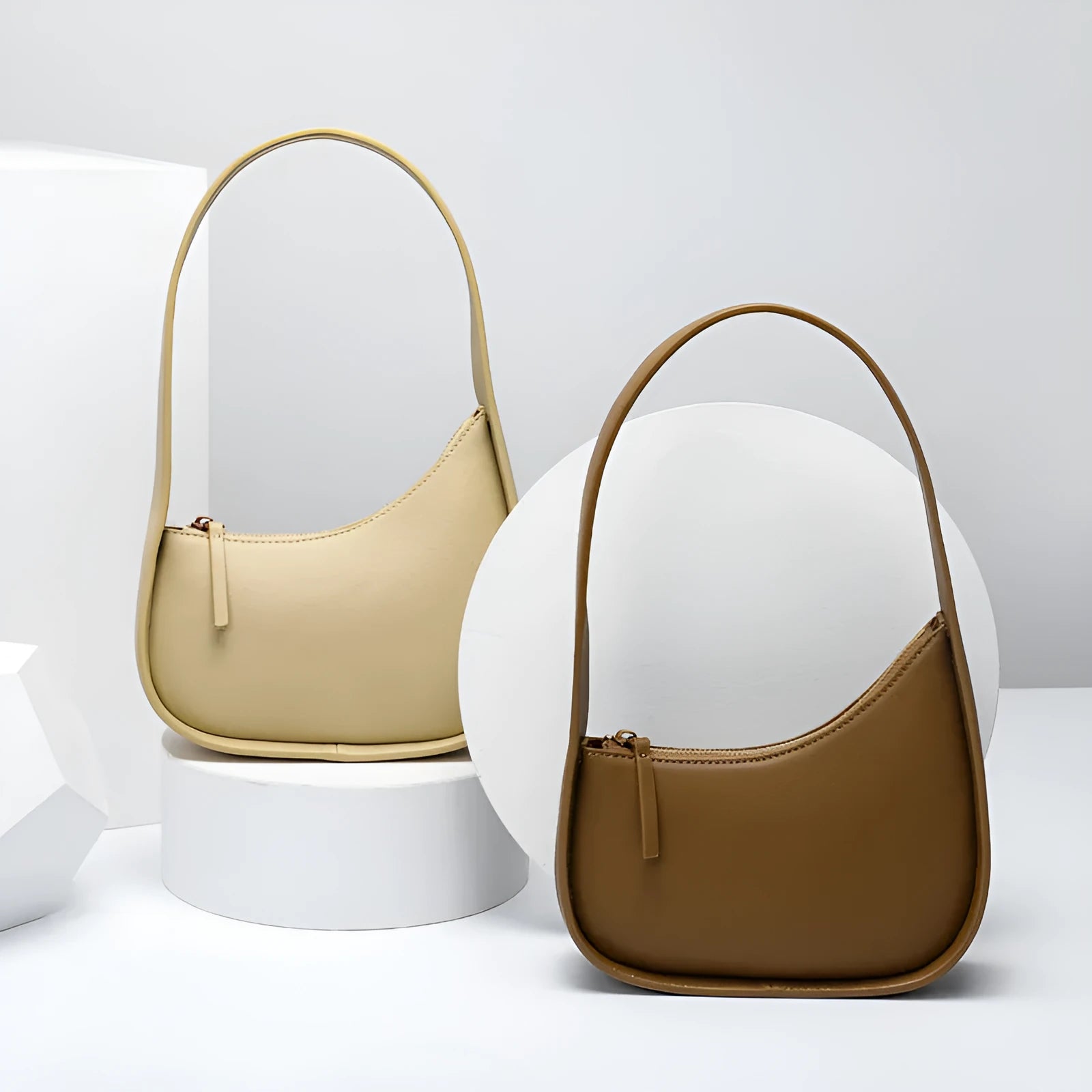 Small brown leather crescent shaped women's shoulder bag with wide strap