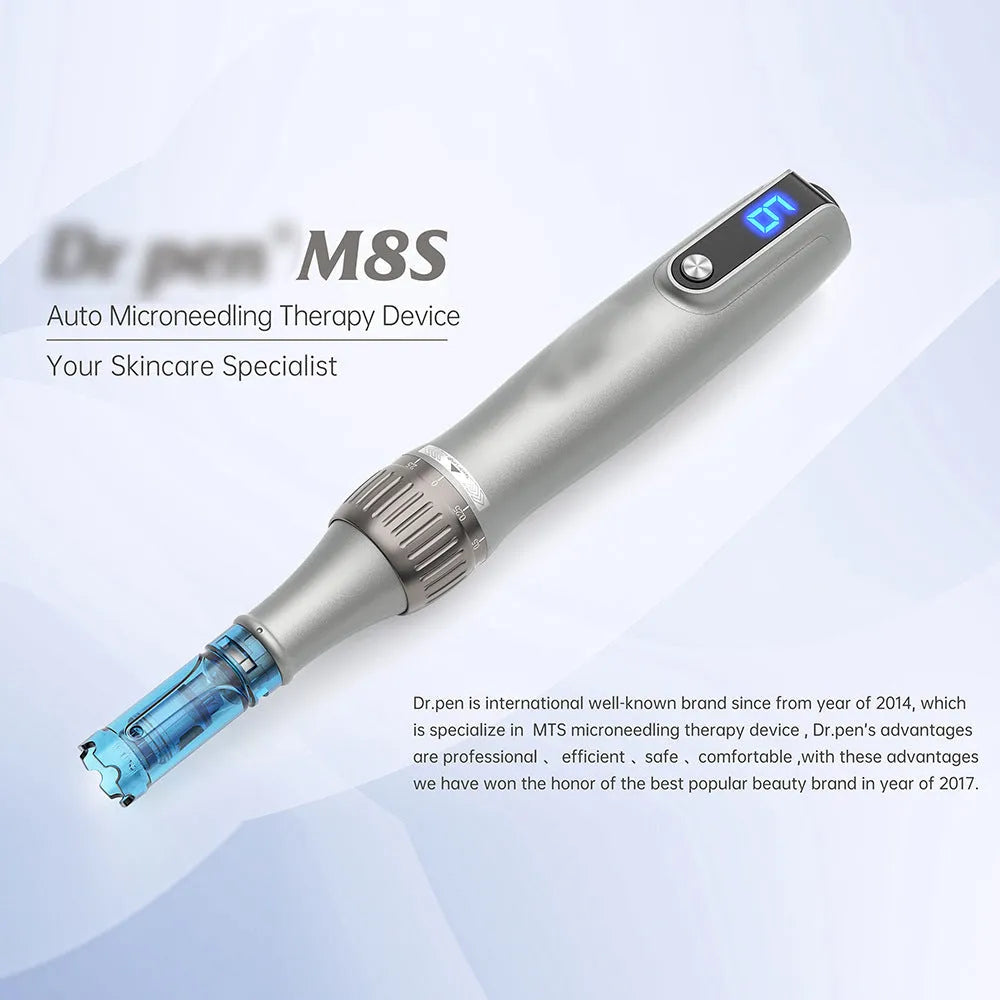 Grey wireless electric micro-needle pen with USB charging port lying on a flat surface