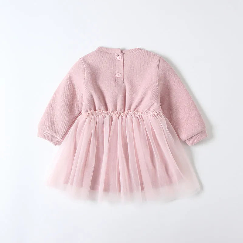 Baby girl pink velvet dress with long sleeves and mesh overlay, front view, sitting pose