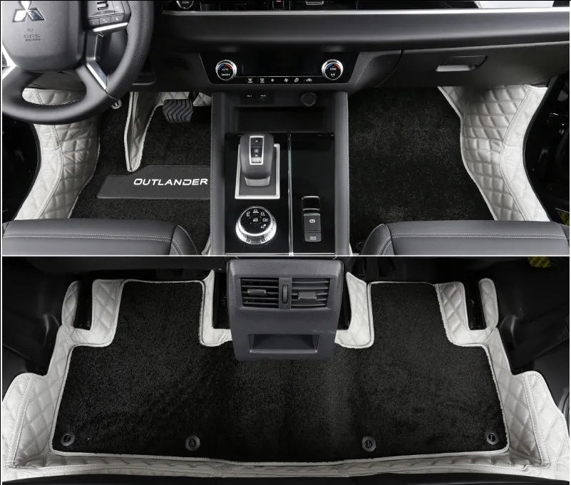 Custom black floor mats installed in a Mitsubishi Outlander footwell.