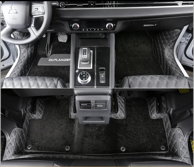 Custom black floor mats installed in a Mitsubishi Outlander footwell.