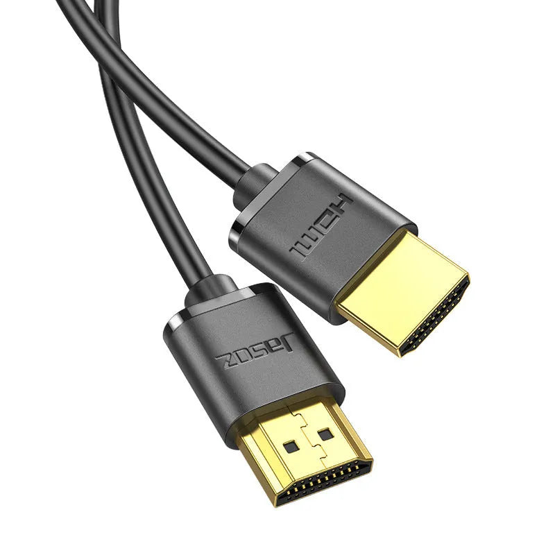 Thin flexible HDMI cable with gold-plated connectors on a white background.