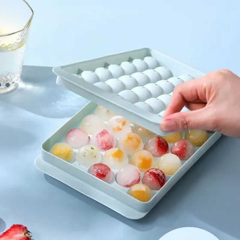Blue round silicone ice cube tray with lid showing 33 large cavities, dimensions 24x14cm.