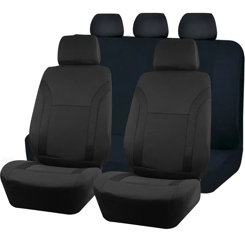 Set of blue polyester car seat covers with eyelet stitching on a vehicle seat.