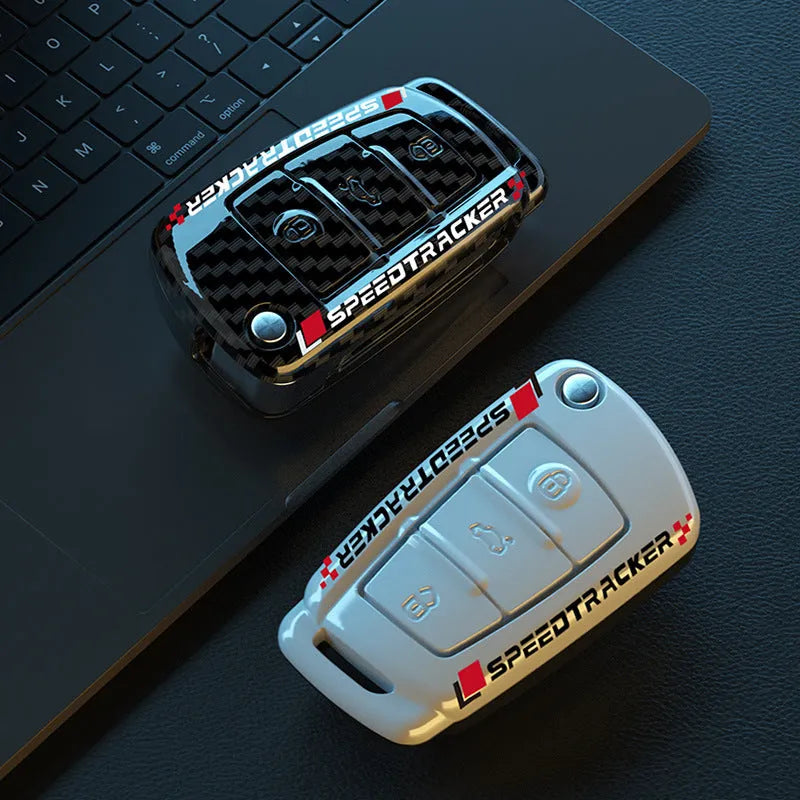 Carbon fibre style car key cover with a small mirror, shown in black and white colour options.