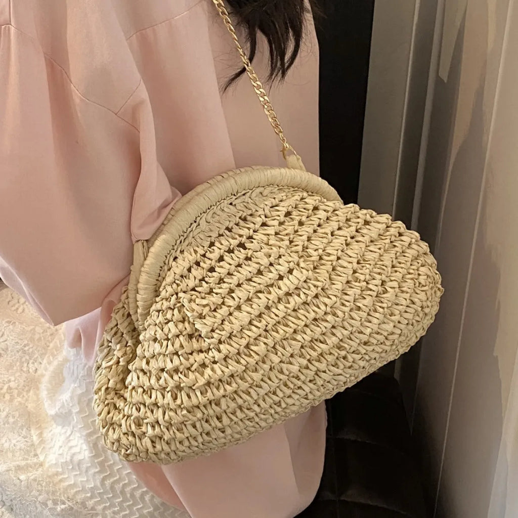 Women's shell-shaped straw shoulder bag with paper construction and zippered interior compartment