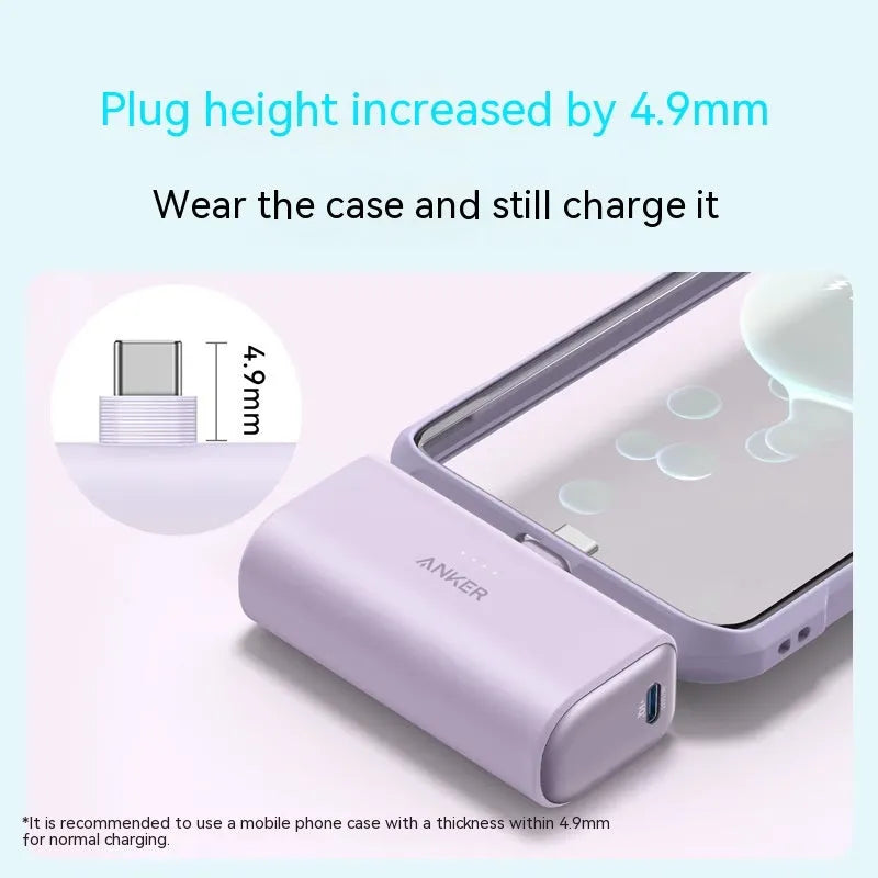 Small black capsule-shaped power bank with a foldable USB-C cable next to it
