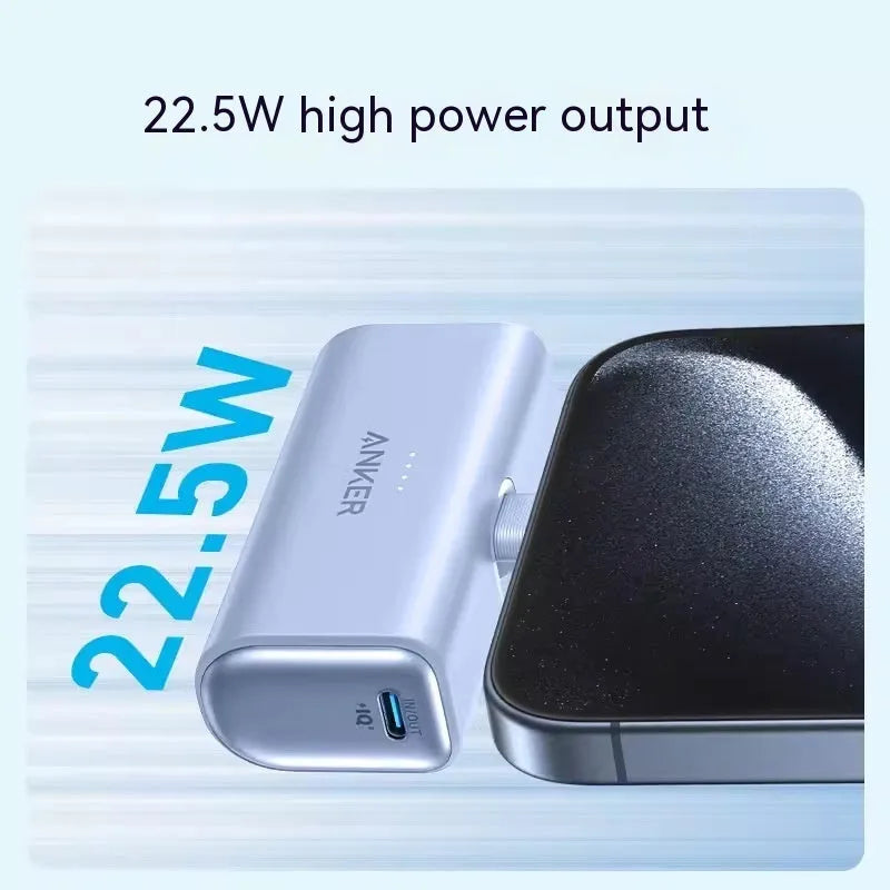 Small black capsule-shaped power bank with a foldable USB-C cable next to it