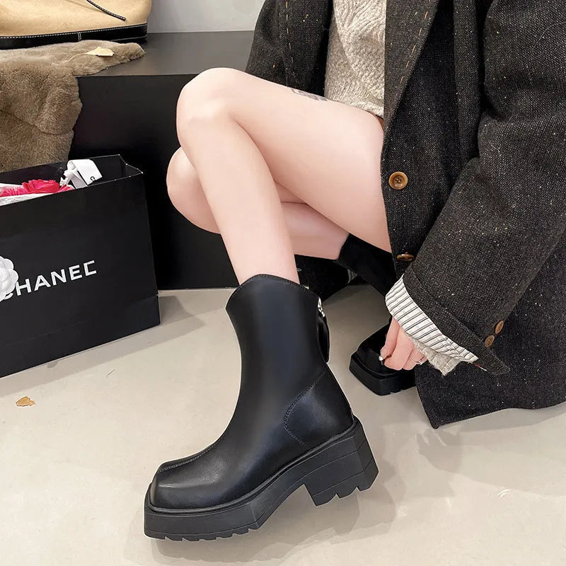 Black women's platform Martin boots with a square toe and back zipper on a neutral background.