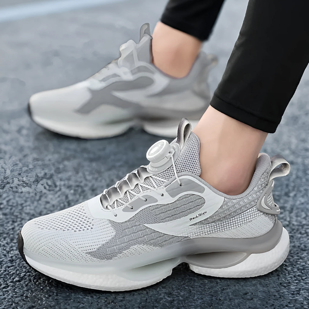 Men's white low-top running shoes with a rotating button buckle and breathable mesh upper.