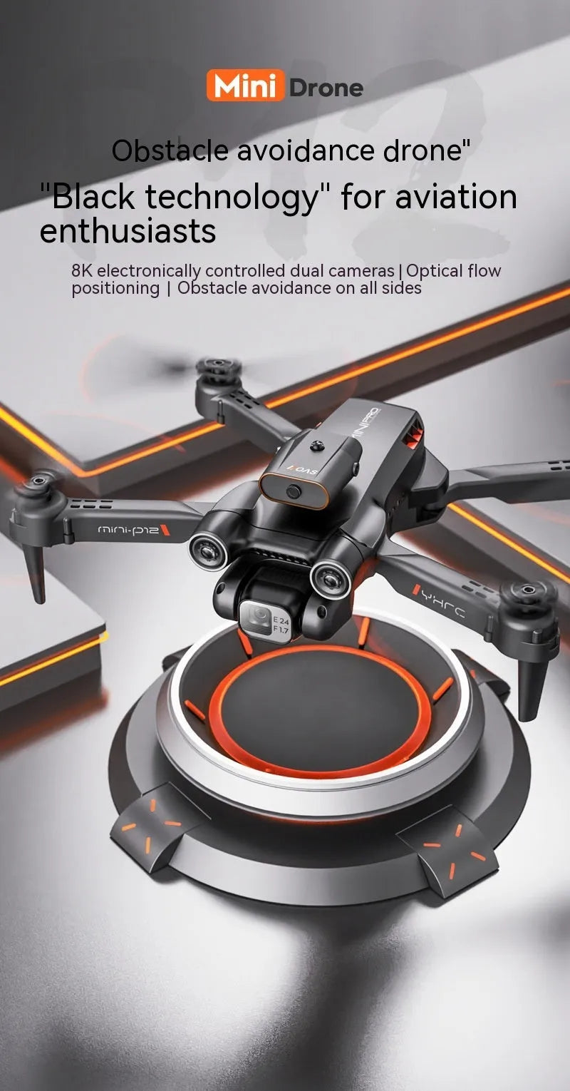 Black quadcopter drone with camera folded on a surface next to its remote control.