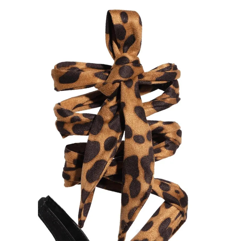Light brown leopard print women's high heels with Roman cross straps and a thin high heel.