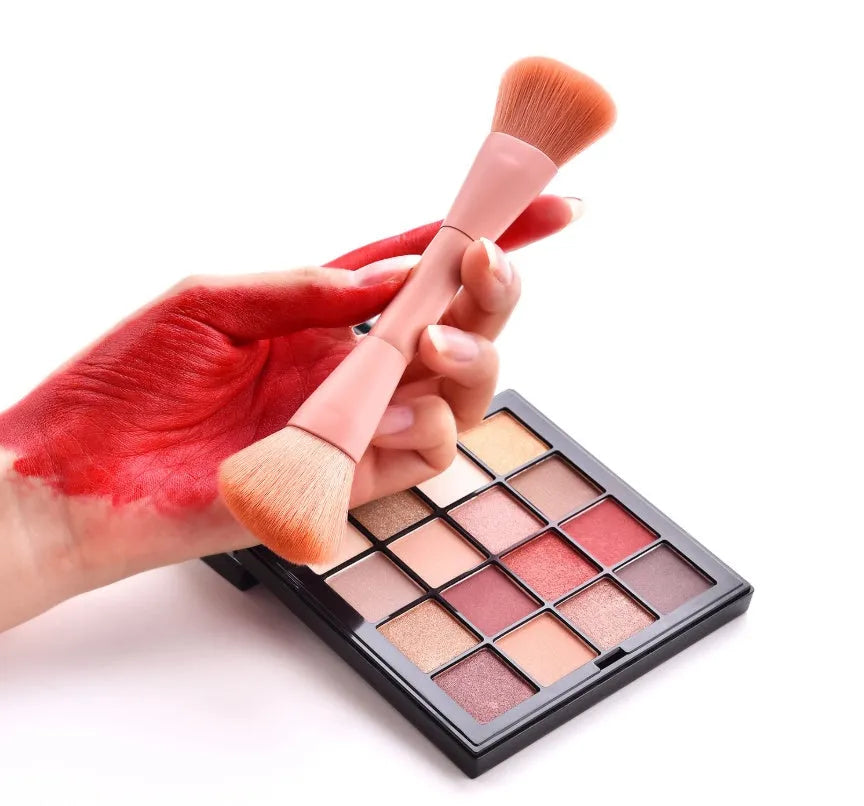 Ten professional makeup brushes with pink painted wooden handles and nylon bristles, including powder, foundation, and double-ended brushes.