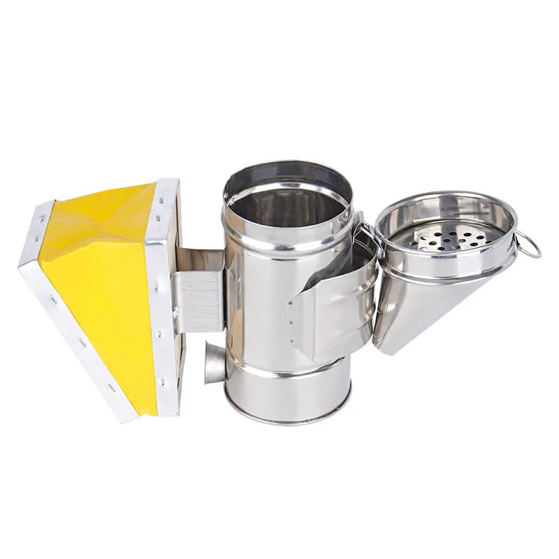 Portable stainless steel beekeeping smoker with leather bellows on a wooden surface