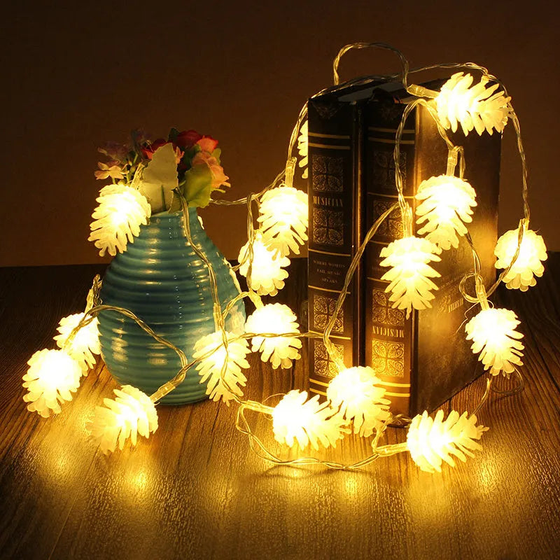 Battery powered LED pine cone light string in warm white colour with plastic shell construction