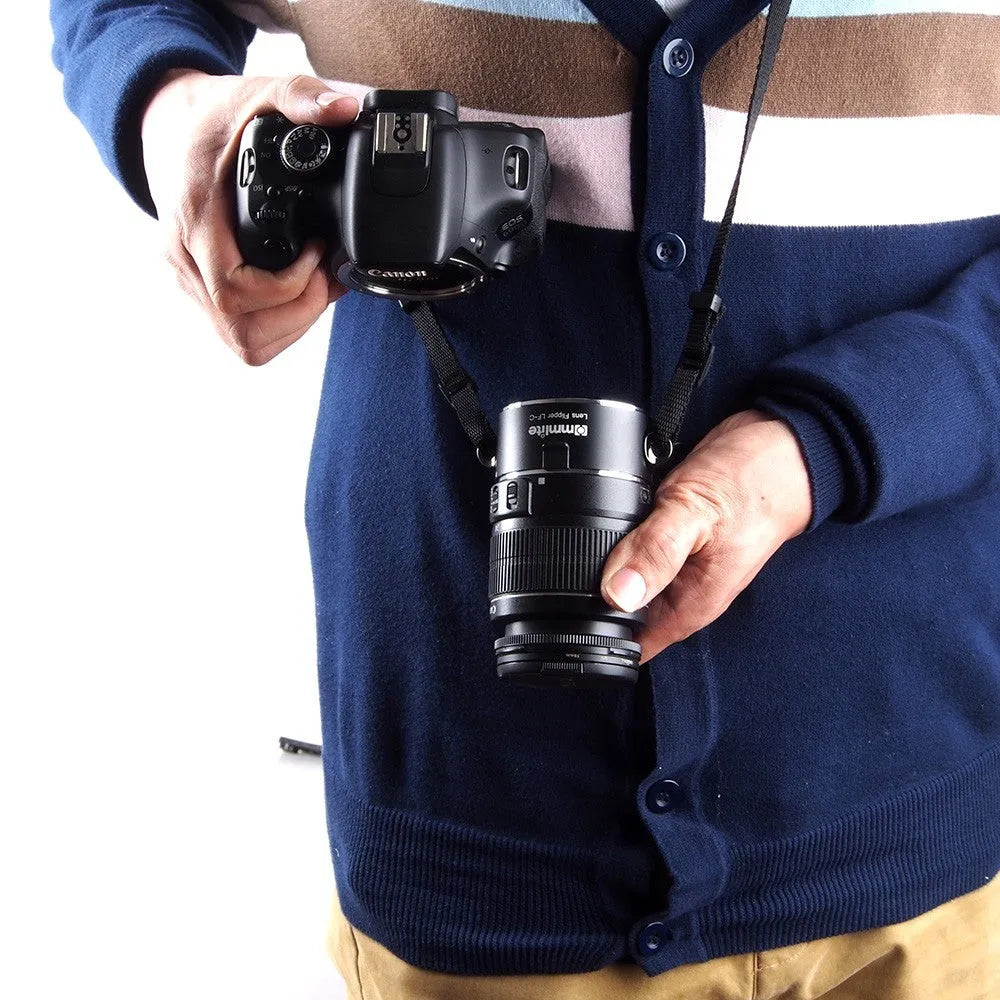 Aluminium alloy camera lens flipper holder with stainless steel buckle on a cotton shoulder strap.