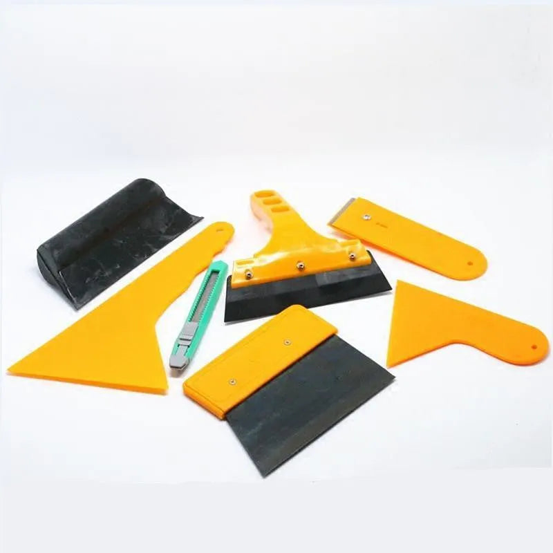 Seven-piece car foil tool set showing scrapers, knives, and a pressing block for film installation.