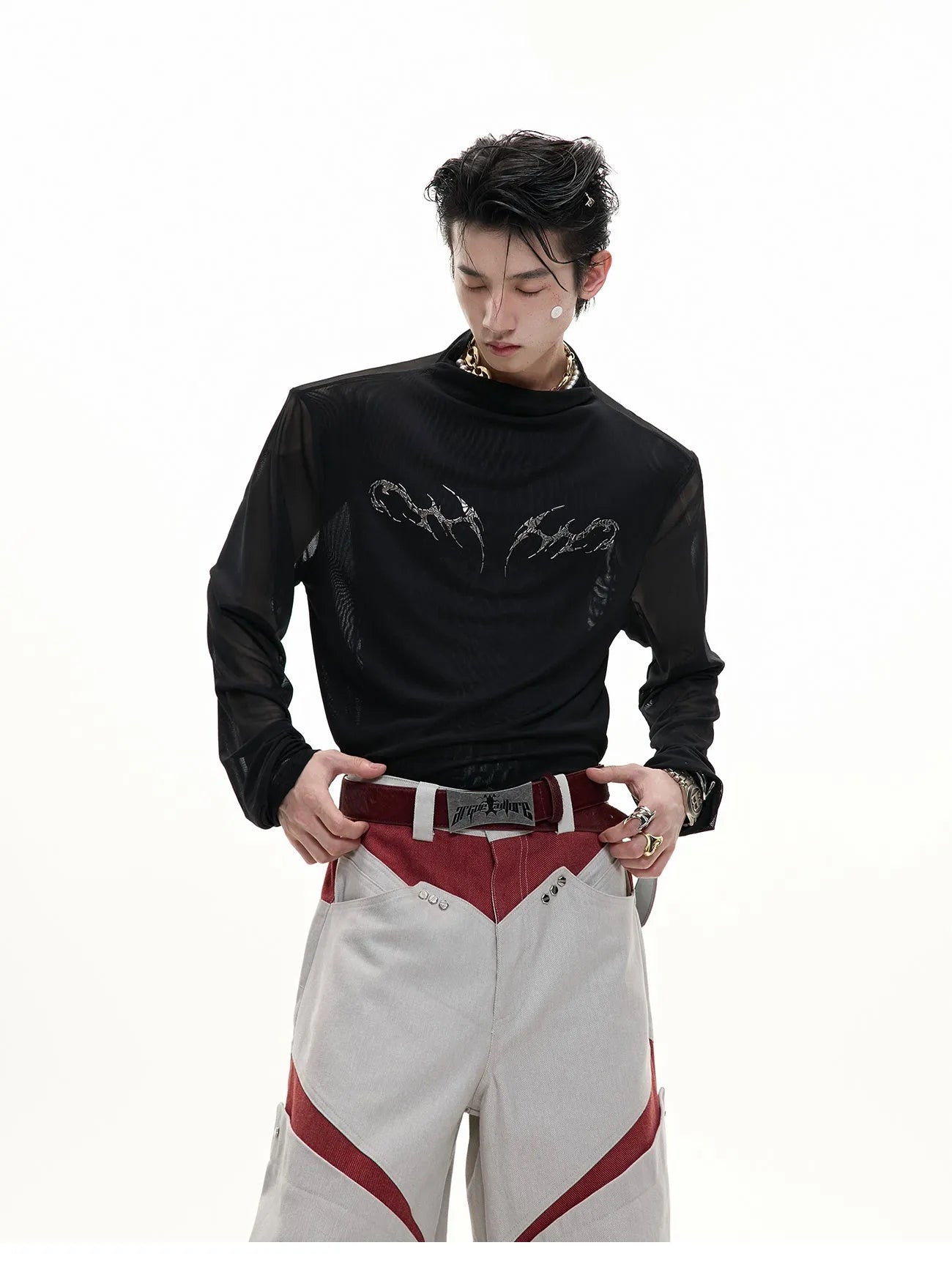 Man wearing a black niche mesh slim-fit long sleeve shirt showing texture and fit.